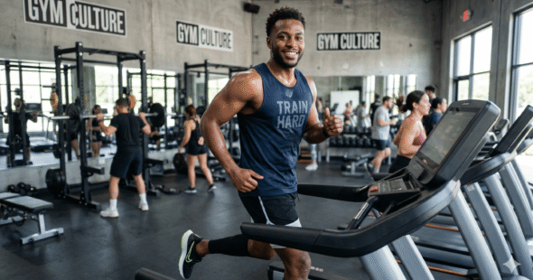 An active man in gym attire looking confident with his secure hair patch during a workout.